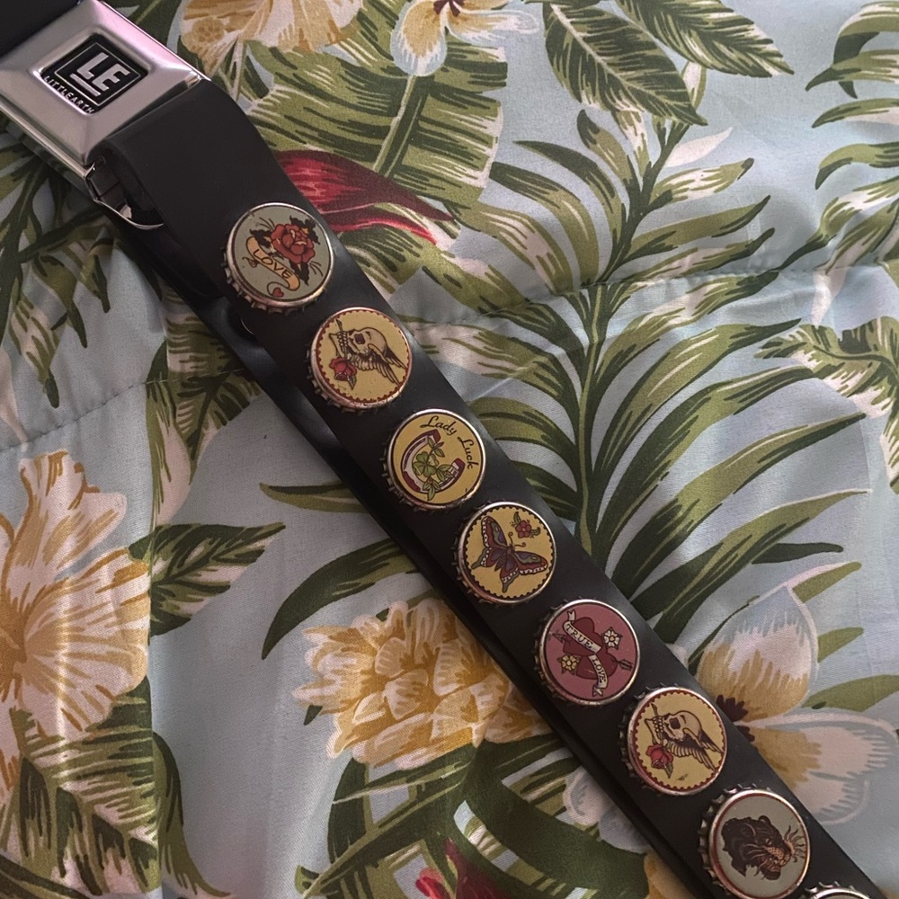 Bottle cap “seat belt” belt